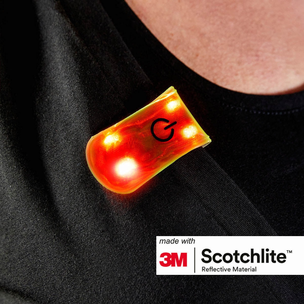 Close up of clip on LED light attached to clothing. 