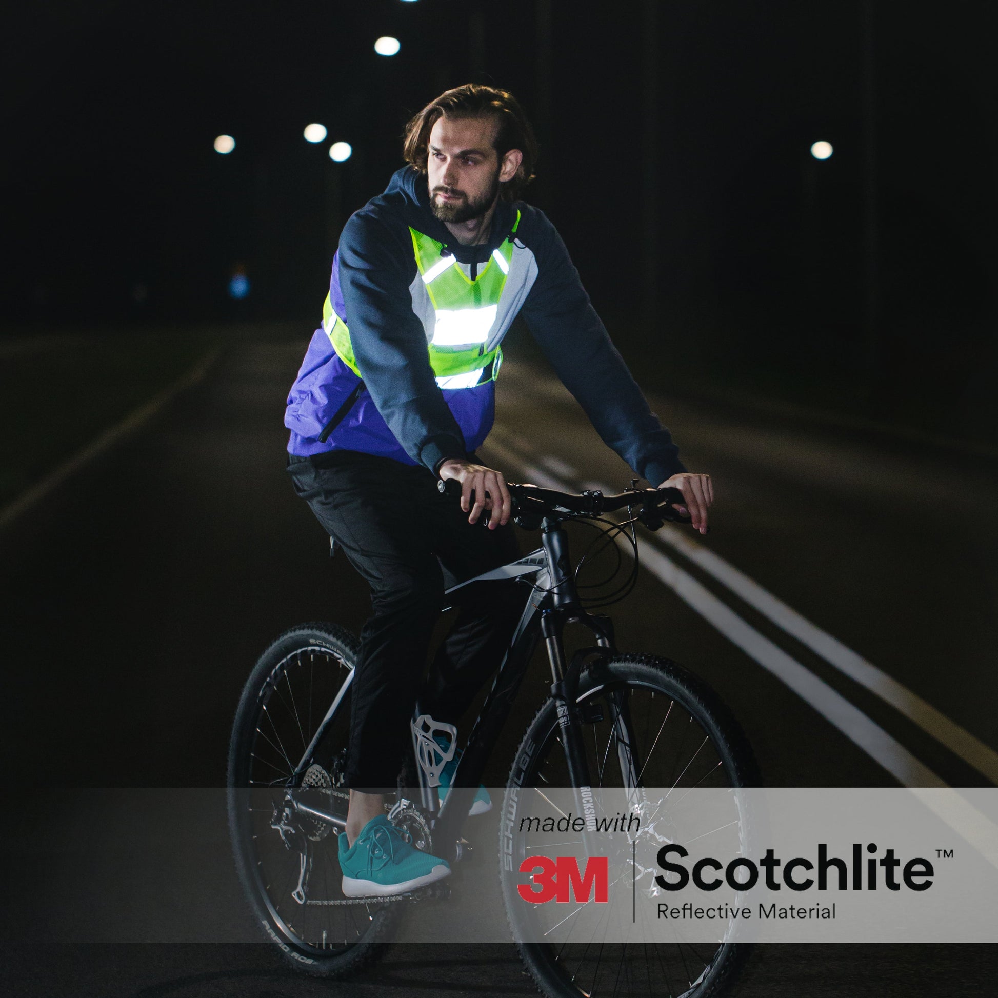 Person outside at night on bike wearing running vest