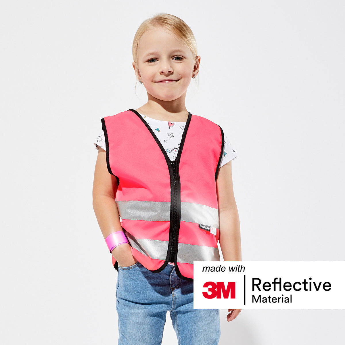 Child wearing red children's vest.