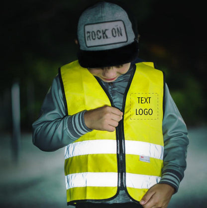 Child standing outside in low lighting wearing yellow children's vest with custom print. 