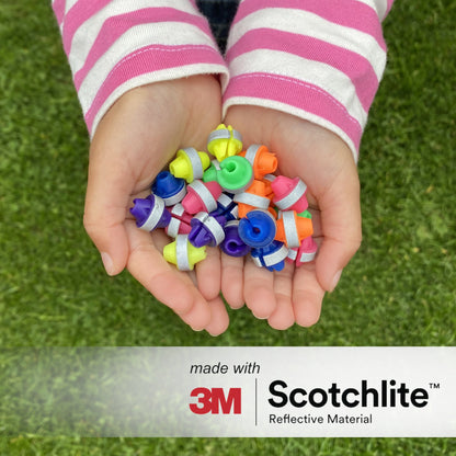 Image of child holding colourful spoke beads in palms. 