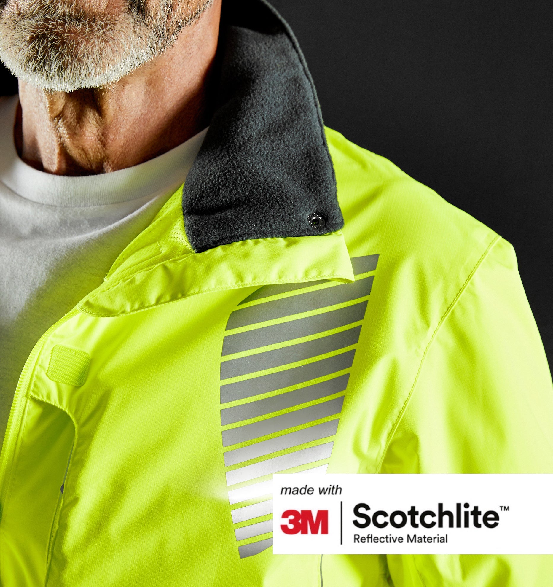 Close up of collar and reflective details of cycling jacket on person. 